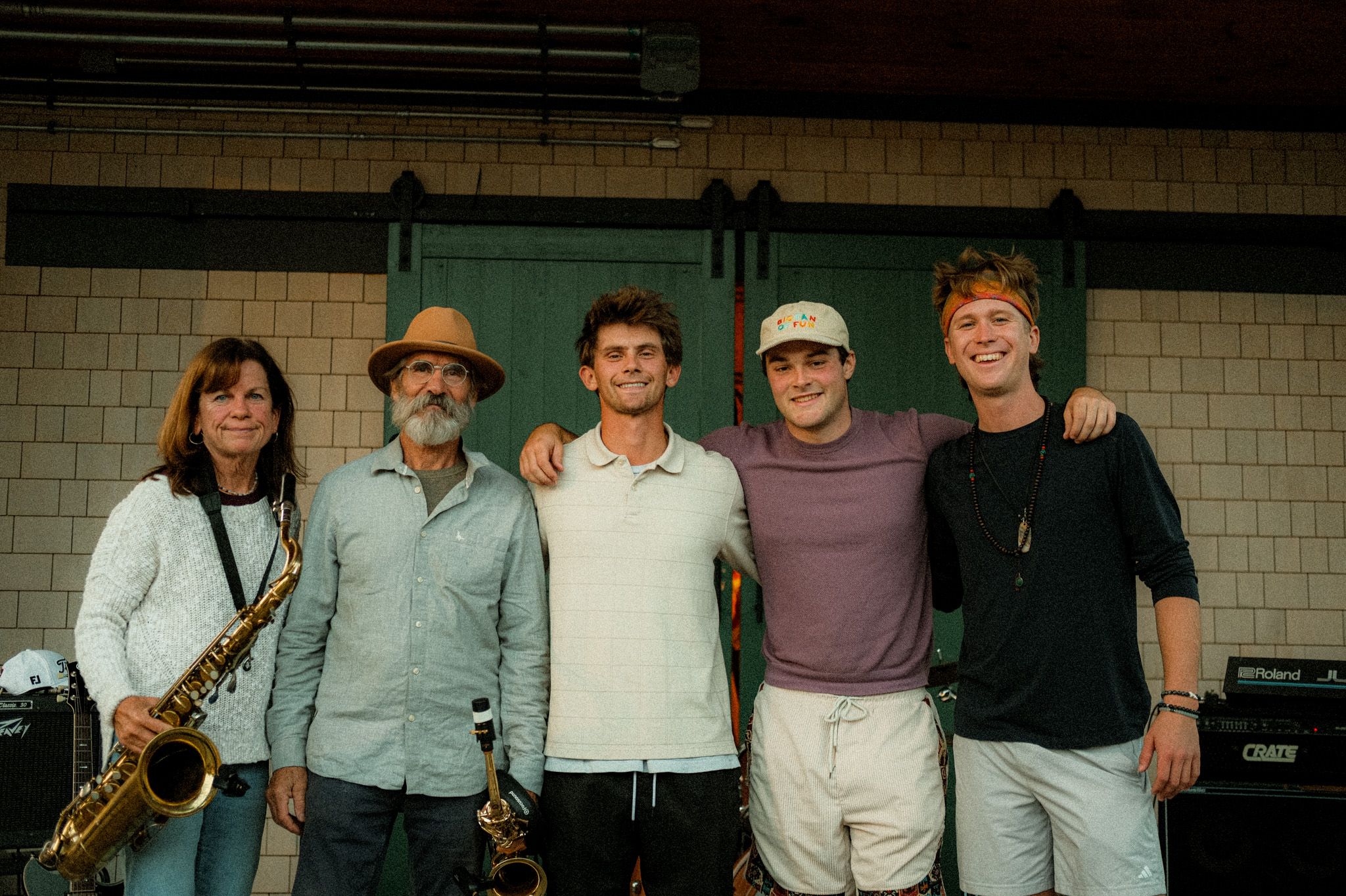 All five members of the band standing together on stage