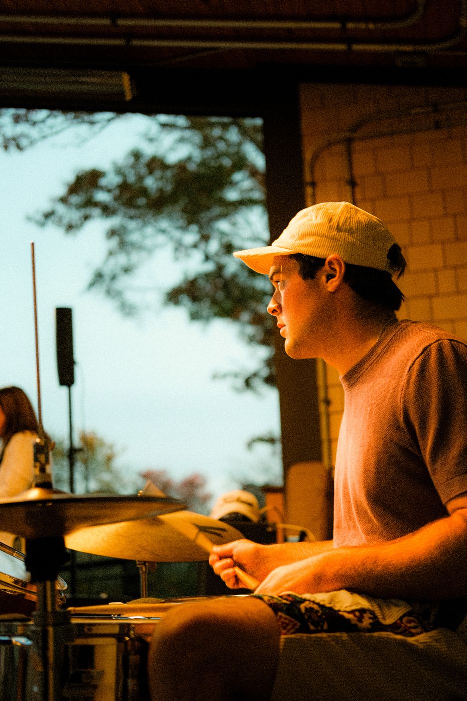 Drummer playing in golden evening light